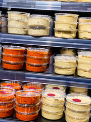 Hummus, ajvar and coleslaw for sale.