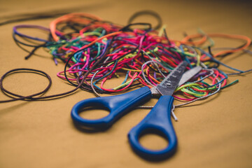 Close-up scissors and colored threads. Colored lines. 
