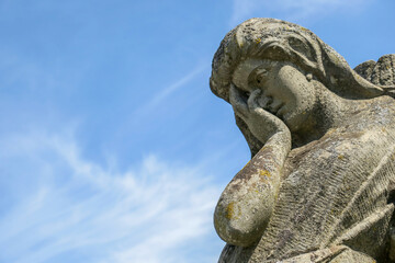 A very sad angel in a stone in the cemetery