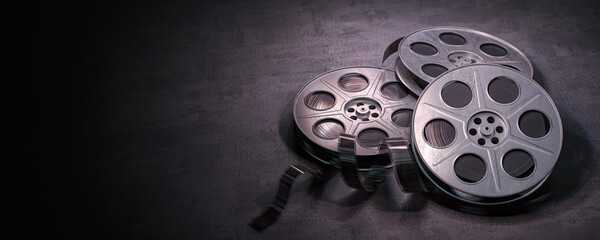 Film reels on black background. Movie, video and cinema prodaction and edition concept. - obrazy, fototapety, plakaty