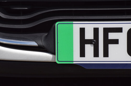A close up of the green strip on a British car number plate that demonstrates the vehicle is an electric zero emissions car in the UK
