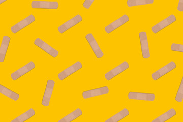 Pattern, beige plaster on yellow background, vaccination concept