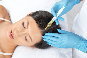 Cosmetologist does prp therapy of a beautiful woman in a beauty salon. Cosmetology concept.