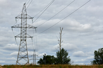an electric pole in a wide field stands