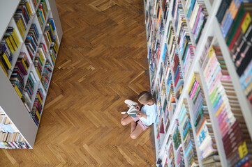 Young girl flipping through the pages of a book