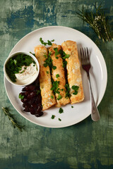 Egg rolls with filling on a white plate. Tinting