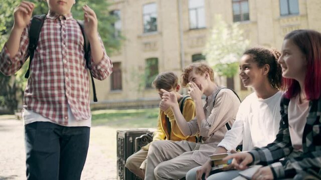 School kids laughing at insecure plump classmate in eyeglasses, weight bullying