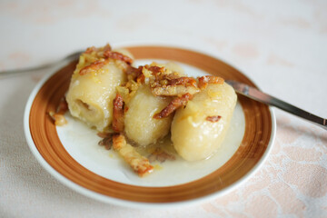 Lithuanian cepelinai, dumplings made of grated and riced potatoes and stuffed with ground meat, dry curd cheese or mushrooms.