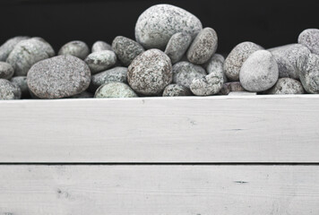 black and white stones on wooden background