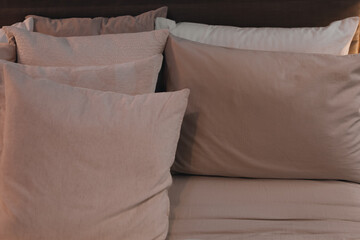 Beige pillows and bedding. Minimalistic style in the interior