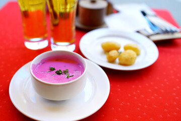 Lithuanian cold beet soup called saltibarsciai. Bright pink soup made of beetroots and kephir and served with boiled potatoes. Tradicional Lithuanian cuisine.