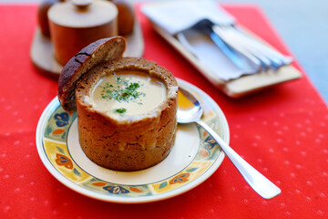 Delicious mushroom cream soup served in bread loaf bowl. National Lithuanian dish.