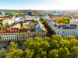 Fototapeta na wymiar Beautiful Vilnius city panorama in autumn with orange and yellow foliage. Aerial evening view.