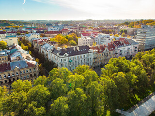 Fototapeta na wymiar Beautiful Vilnius city panorama in autumn with orange and yellow foliage. Aerial evening view.