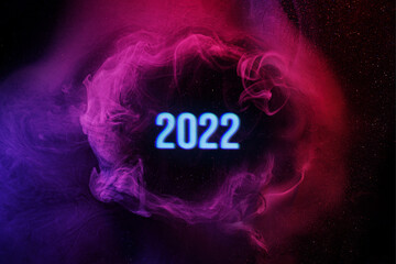 2022 year. Mockup for your logo. Art photo of purple smoke moves on black background. Beautiful swirling colorful smoke.