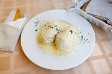 Lithuanian cepelinai, dumplings made of grated and riced potatoes and stuffed with ground meat, dry curd cheese or mushrooms. © MNStudio