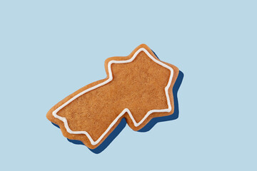 Decorated gingerbread star on pastel blue background