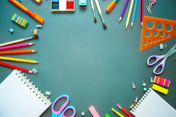 Office supplies are scattered on a table or a blackboard. Back to school. Flat lay. Copy space.