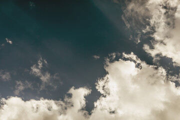 Blue sky with thunderclouds, dark clouds and sunrays