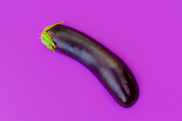 Ripe long eggplant on an eggplant background. Cooking vegetables