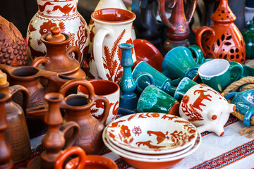 Ukrainian pottery. Pottery museum in Ukrainian village Oposhnya, center of Ukrainian pottery production. Different pottery products: bowls, pitchers, plates in museum.