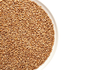 Kernel of grits from whole undivided buckwheat grains, in a plate, close-up, fried buckwheat, having a brown tint