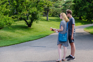 Mother and son looking at a map along a urban pathway