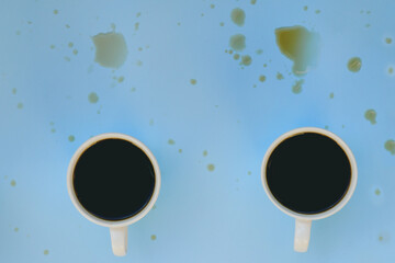 Businessman working morning with cups of hot black coffee on blue background. Coffee blots on the table. Top view, copy space, mockup. Flat lay. Modern breakfast concept.