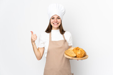 Young woman in chef uniform isolated on white background giving a thumbs up gesture