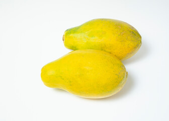 Two whole papaya over a white background. View from above.