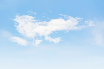 The blue sky is tinged with white clouds in the air on a bright summer day.