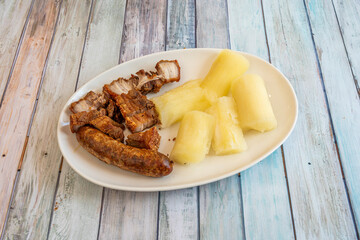 pieces of fried pork rinds with fried chorizo and fried yucca served in an Ecuadorian restaurant