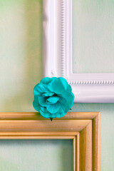 Green painterly background with wood and white picture frames and green paper flower; design of two picture frame corners with paper flower