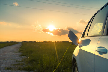 Charging an electric car with power supply cable.