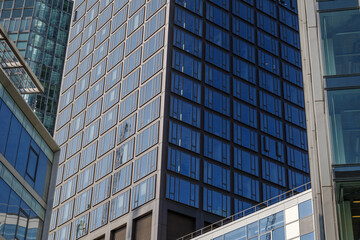 Fototapeta na wymiar Exterior architectural detail modern facade of High-rise office buildings. Abstract Urban metropolis background.