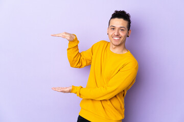 Caucasian man over isolated background holding copyspace to insert an ad