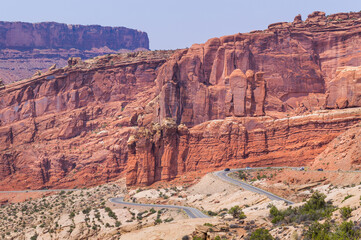 Orange color sandstone natural wall and the highway in the Arches National Park, Utah, USA