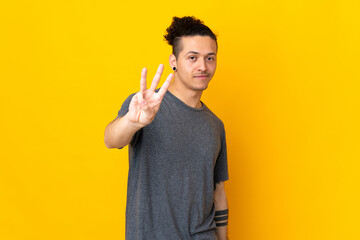 Caucasian man over isolated background happy and counting three with fingers