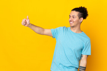 Caucasian man over isolated background giving a thumbs up gesture