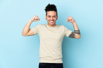 Caucasian man over isolated background doing strong gesture