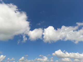 Naklejka na ściany i meble Cloudy sky. Blue sky with white clouds on summer day without rain.