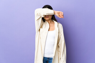 Young brunette woman over isolated purple background covering eyes by hands