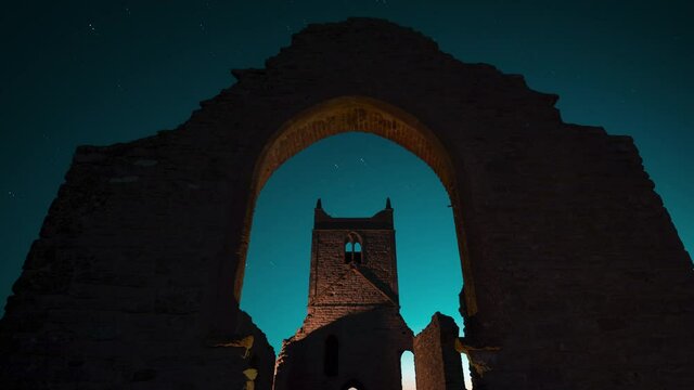 Light painting reveals ancient ruins of old church "Burrow Mump" at night 