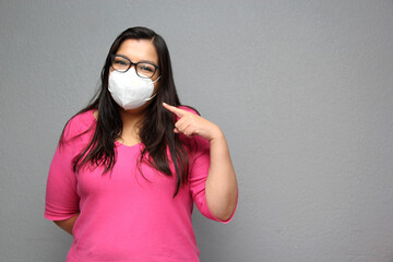 Latino adult woman with glasses wearing face masks for protection from Covid-19 due to the pandemic
