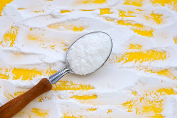 Baking soda on yellow background.