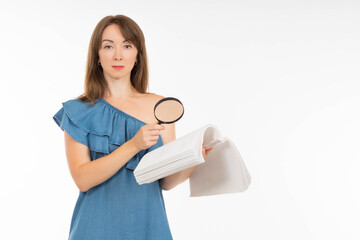 Study of contract concept. Woman with papers and magnifying glass. She reads contract carefully. Businesswoman in jeans dress. Businesswoman with contract and magnifying glass. Verification documents