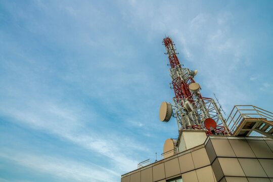 Large telecommunication tower against sky and clouds in background . Internet network connection concept .