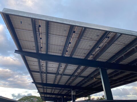 Solar paneled carport in a Hawaii parking lot help to offset high electricity costs.