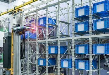 plastic boxes in the cells of the automated warehouse. Metal construction warehouse shelving