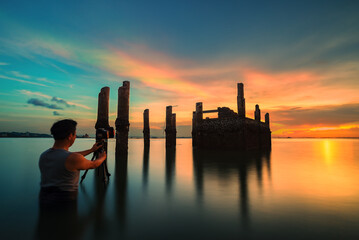 silhouette of photographer taking picture of landscape during sunset. Lifestyle Concept